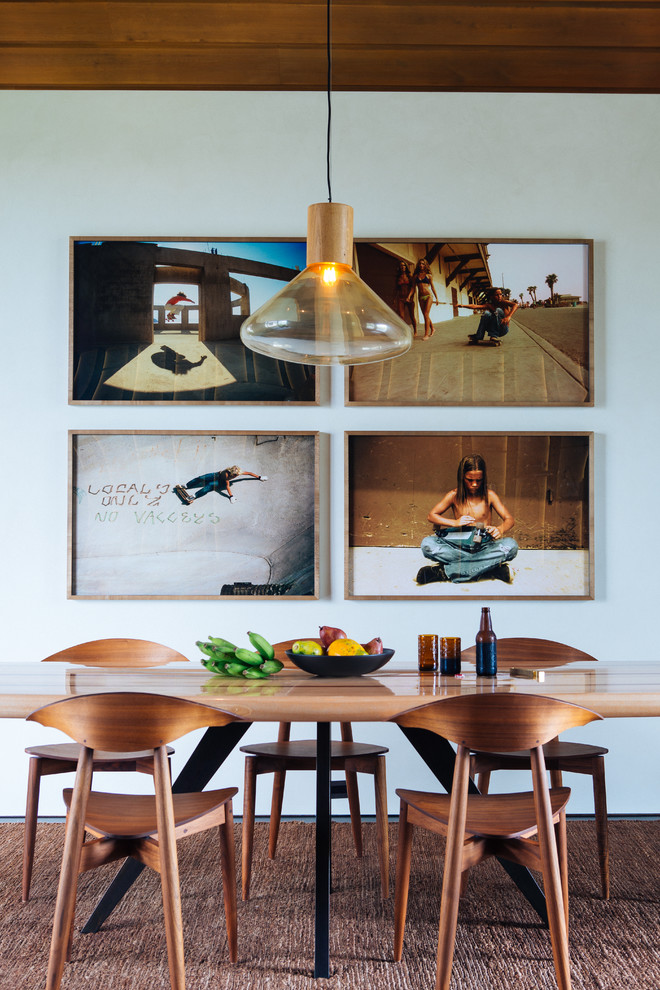 This is an example of a world-inspired dining room in Hawaii with white walls.