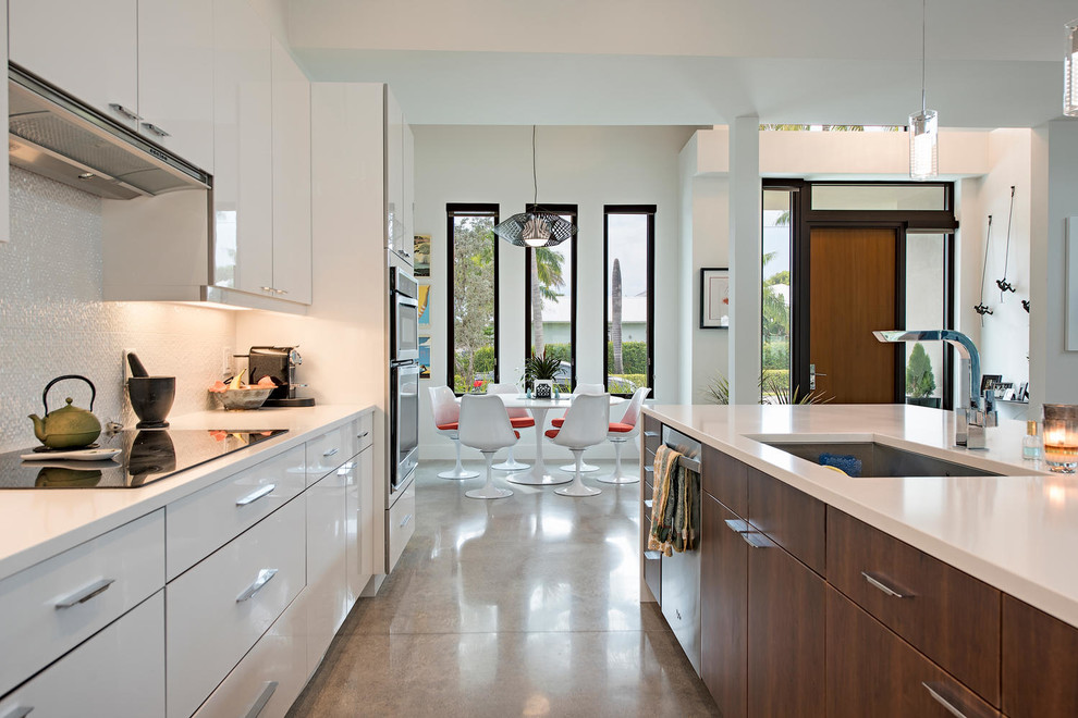 Immagine di una piccola cucina abitabile moderna con pavimento in cemento e pavimento marrone