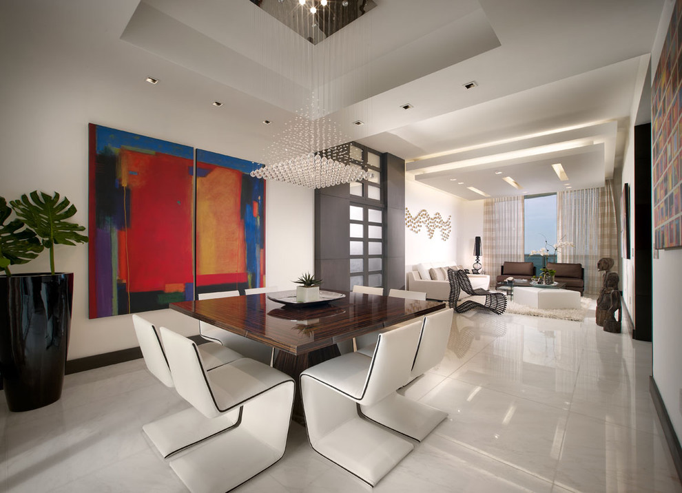 This is an example of a contemporary open plan dining room in Miami with marble flooring.