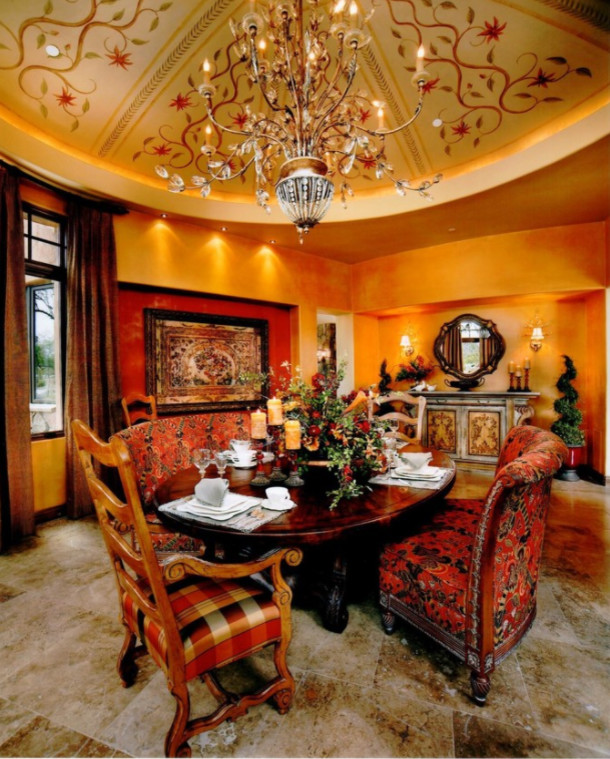 This is an example of a small mediterranean open plan dining room in Phoenix with orange walls.