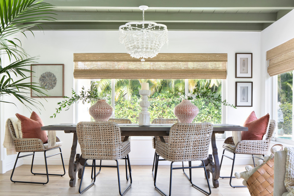 Bohemian dining room in Miami with white walls, medium hardwood flooring, brown floors and exposed beams.