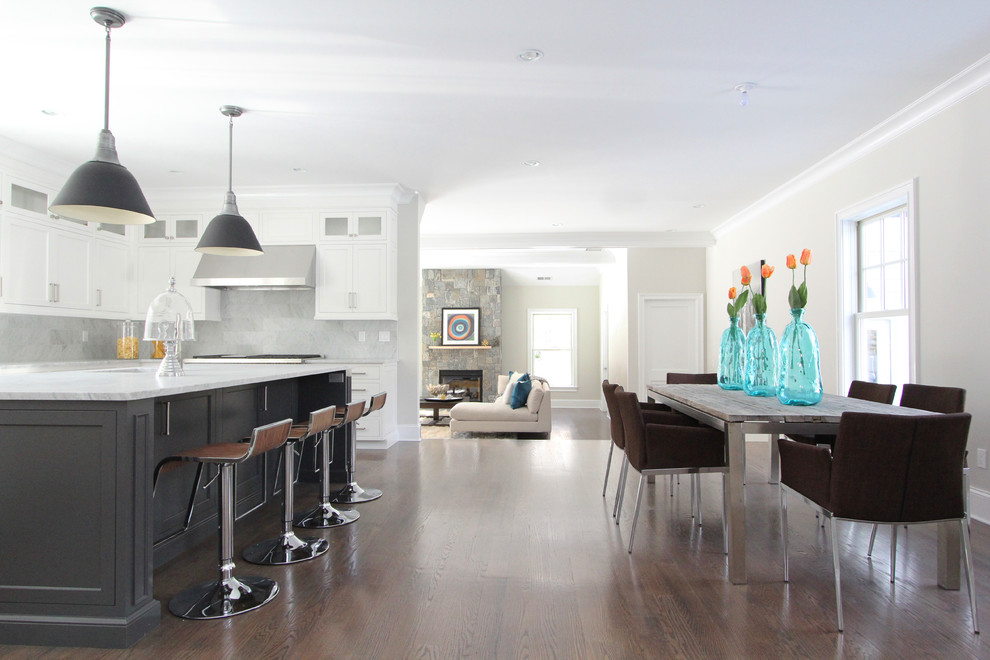 This is an example of a large modern kitchen/dining room in New York with grey walls, dark hardwood flooring and no fireplace.