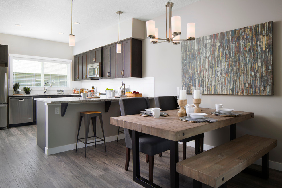 This is an example of a medium sized traditional open plan dining room in Calgary with grey walls, light hardwood flooring and no fireplace.