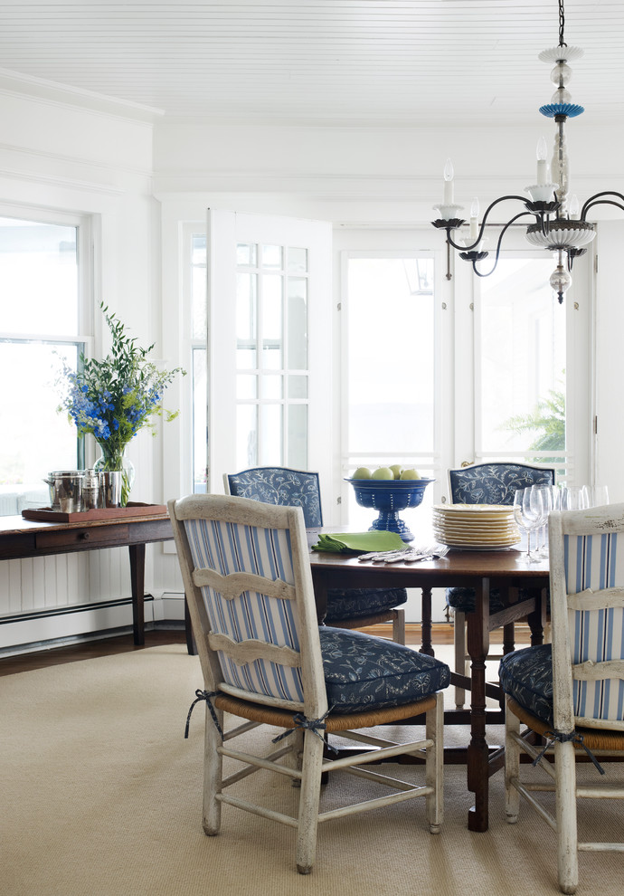 Example of a beach style dining room design in Chicago with white walls