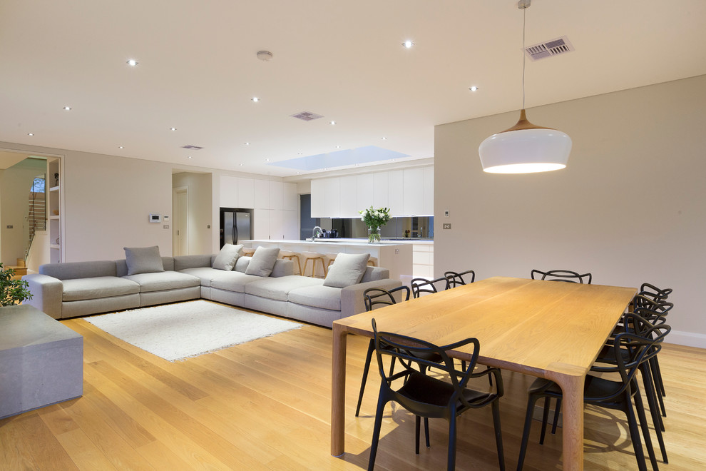 Great room - contemporary plywood floor great room idea in Sydney with white walls and a ribbon fireplace