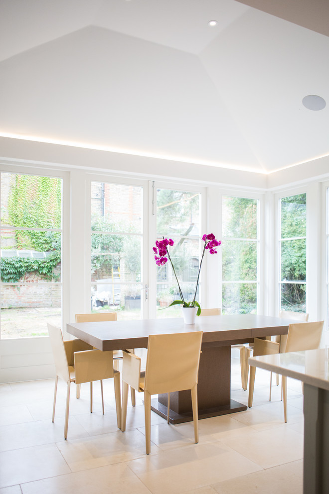 Medium sized classic kitchen/dining room in London with limestone flooring and beige floors.