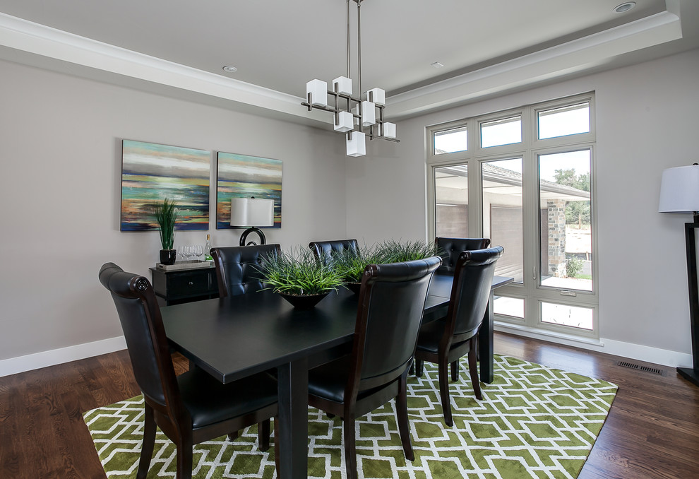 Photo of a large contemporary enclosed dining room in Other with grey walls, medium hardwood flooring and no fireplace.