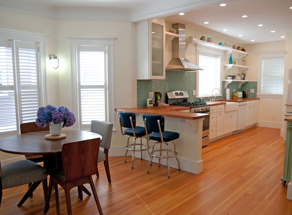 Mittelgroße Mid-Century Wohnküche ohne Kamin mit gelber Wandfarbe und braunem Holzboden in Boston
