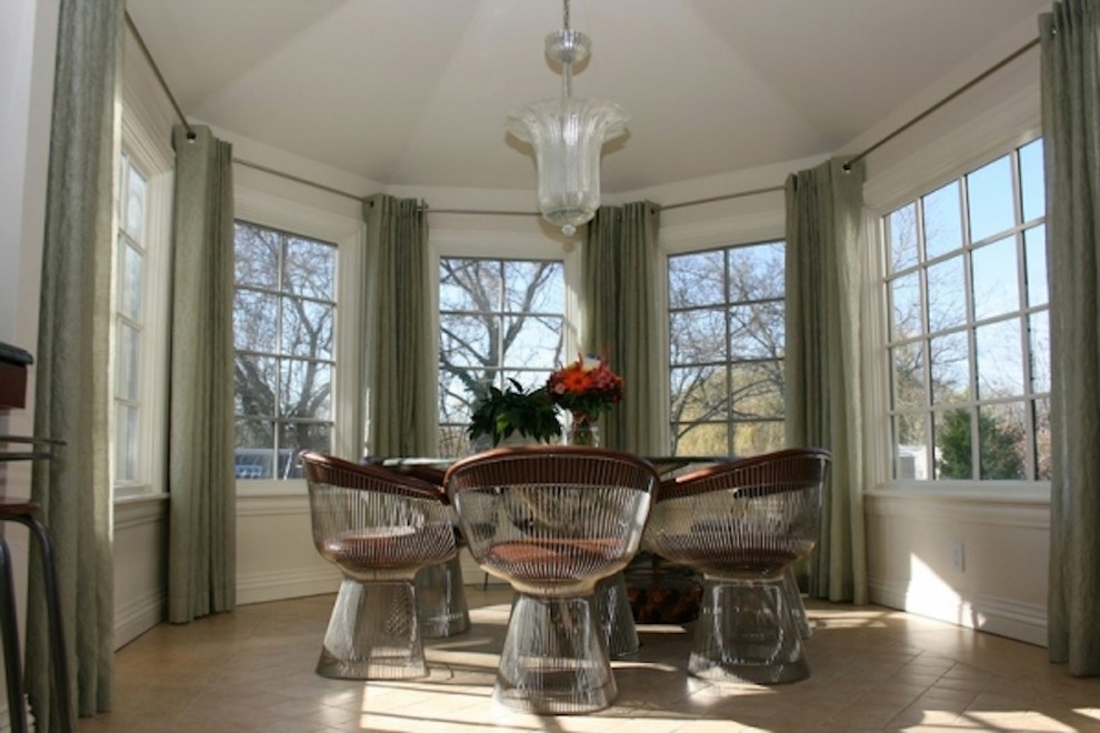 Photo of a small traditional enclosed dining room in New York with white walls, porcelain flooring and no fireplace.