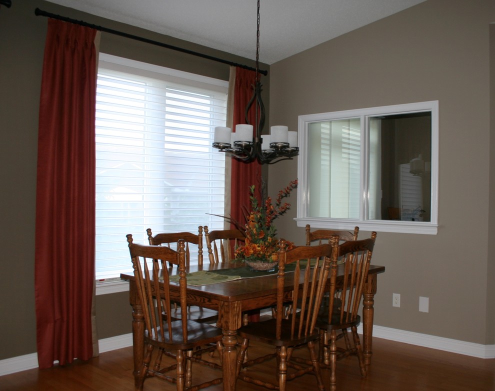 Photo of a medium sized classic dining room in Ottawa with medium hardwood flooring, no fireplace, beige walls, brown floors and a vaulted ceiling.