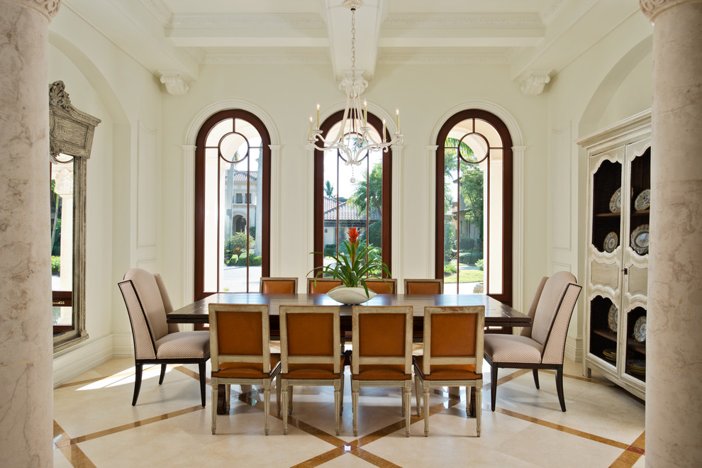 Example of a large tuscan dining room design in Miami with white walls