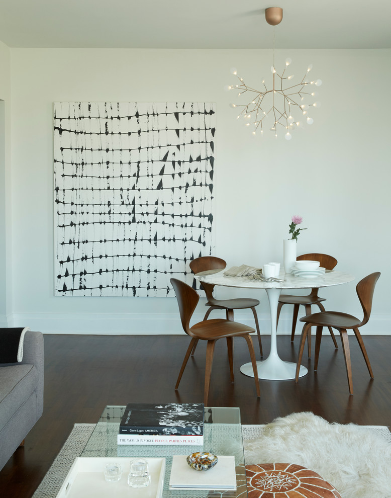 Photo of a small modern open plan dining room in Other with white walls and dark hardwood flooring.