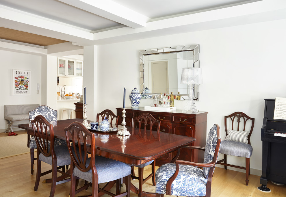 Photo of a medium sized classic open plan dining room in New York with white walls and light hardwood flooring.