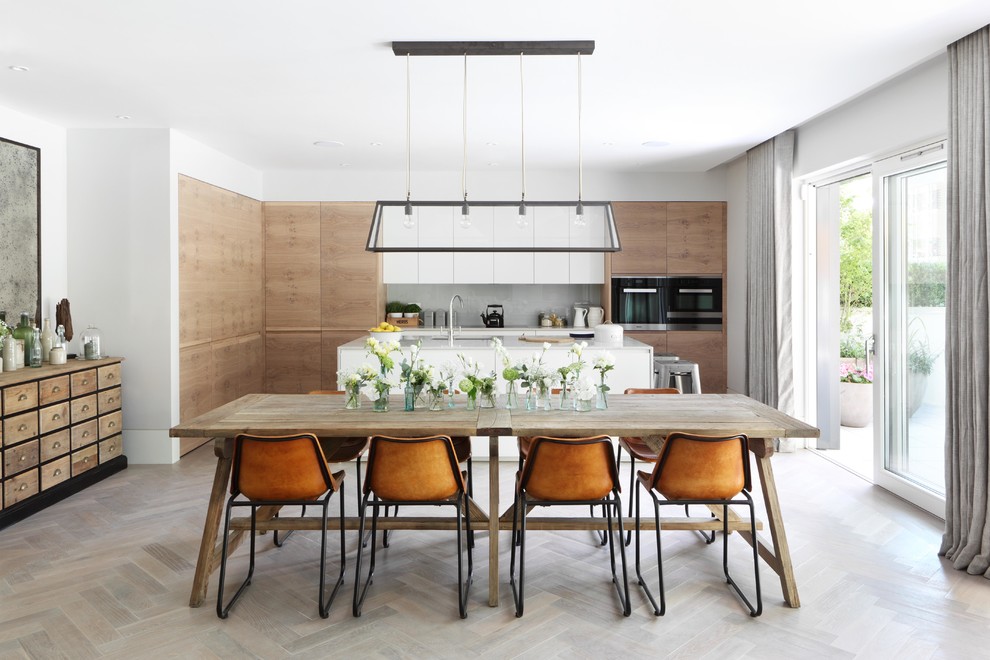 Example of a trendy medium tone wood floor and gray floor great room design in London with white walls and no fireplace