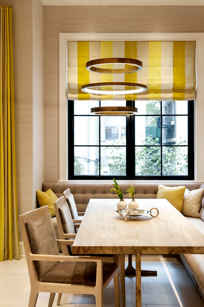 This is an example of a contemporary dining room in New York with beige walls.