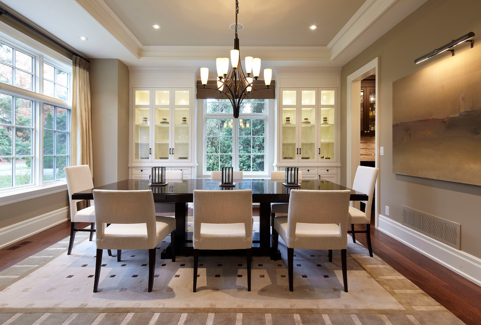 Inspiration for a large transitional medium tone wood floor enclosed dining room remodel in Toronto with brown walls