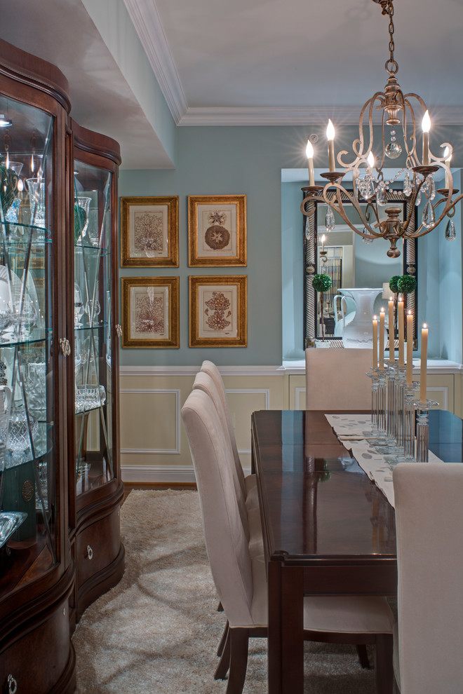 Elegant medium tone wood floor enclosed dining room photo in Baltimore with blue walls