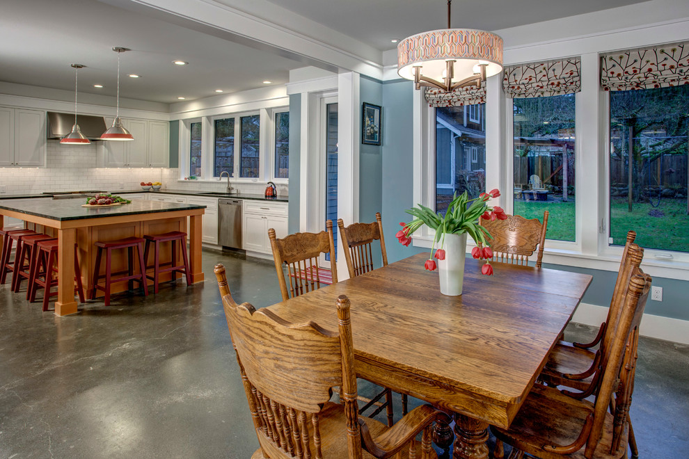 This is an example of a medium sized rural dining room in Seattle with concrete flooring.