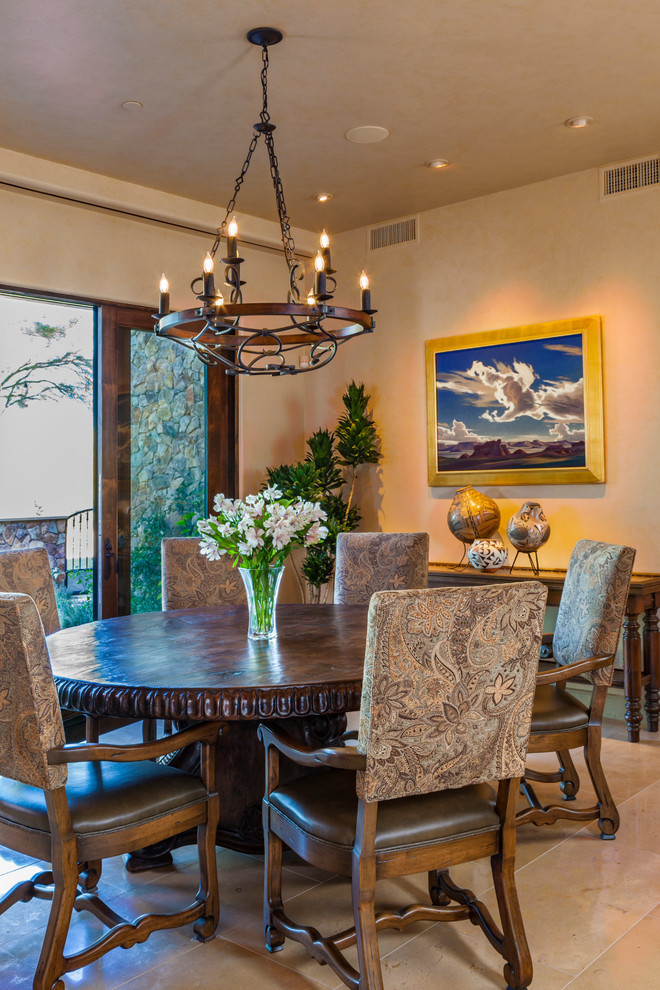 This is an example of a medium sized rustic open plan dining room in Phoenix with beige walls, limestone flooring, no fireplace and beige floors.