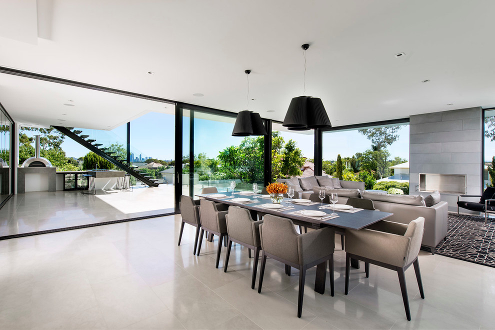 Photo of a large contemporary dining room in Perth with a standard fireplace and a tiled fireplace surround.