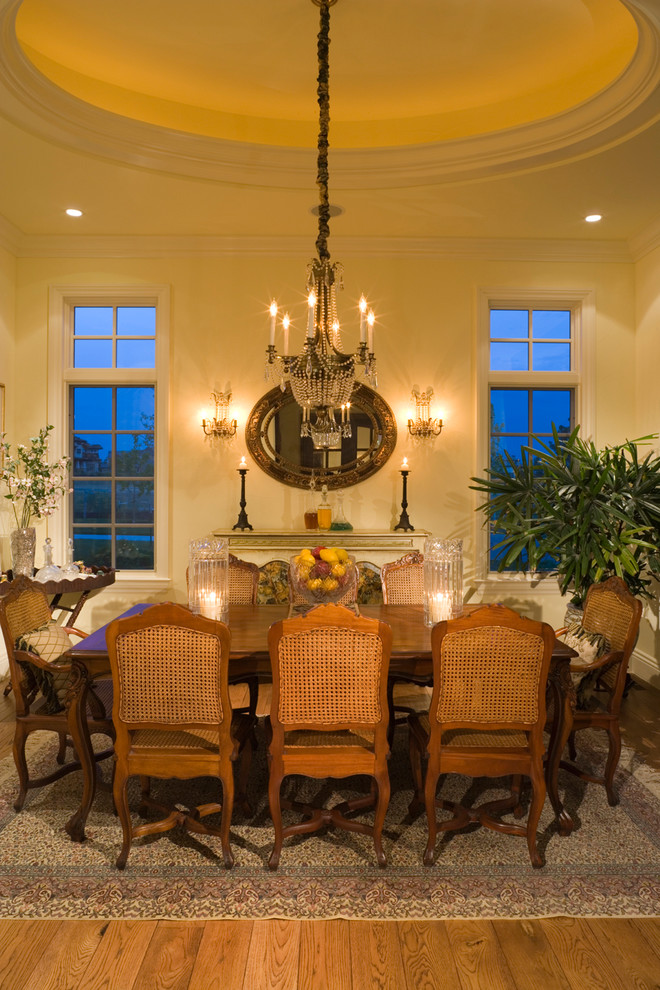 Elegant medium tone wood floor dining room photo in Denver with beige walls