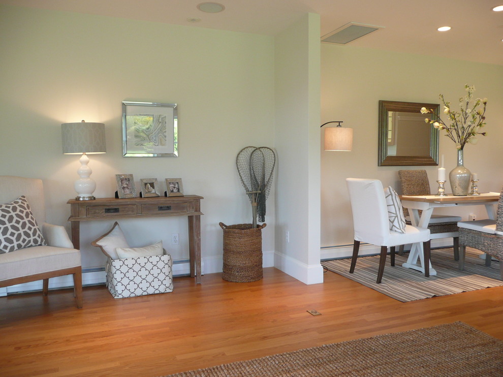 Small coastal open plan dining room in Boston with white walls and light hardwood flooring.