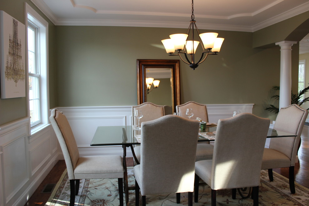 Esempio di una sala da pranzo chic chiusa e di medie dimensioni con pareti verdi, parquet scuro, nessun camino e pavimento marrone