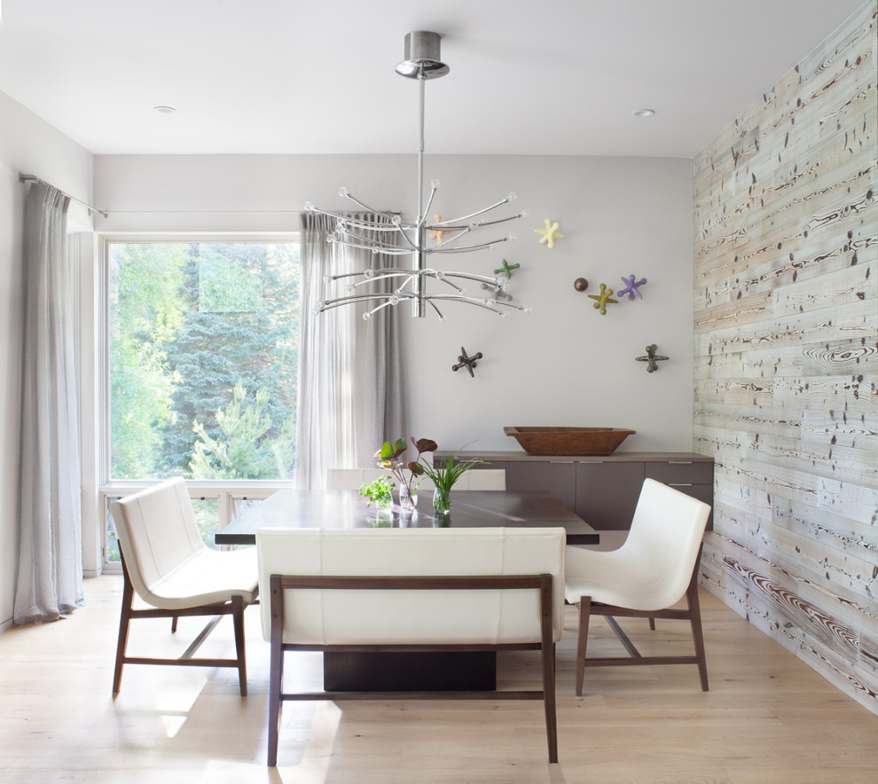 Example of a trendy light wood floor and beige floor dining room design in Denver with gray walls