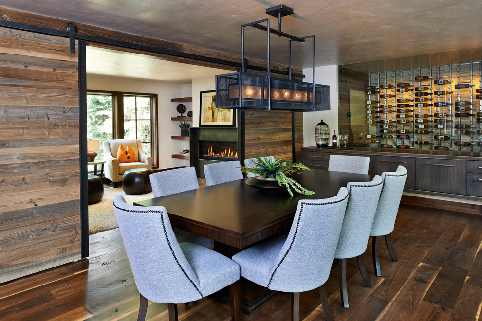 Inspiration for a rustic dark wood floor enclosed dining room remodel in Denver with white walls
