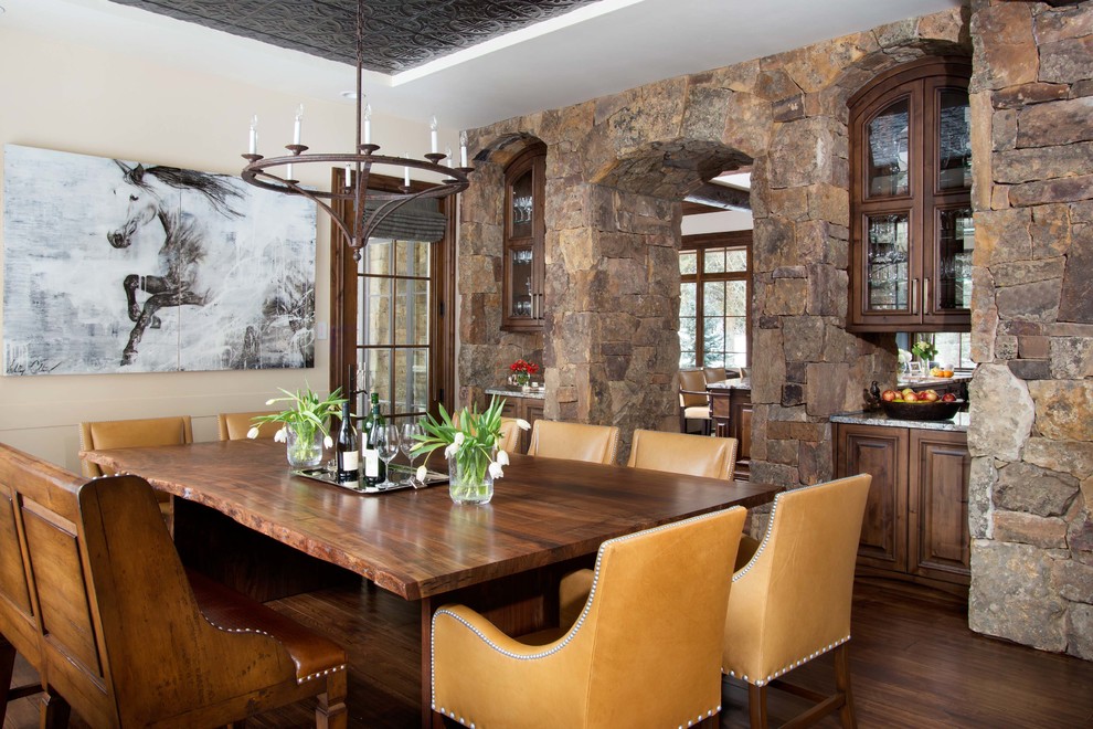 Example of a mountain style dark wood floor dining room design in Denver with beige walls