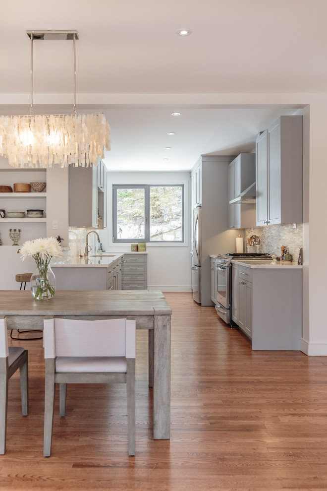 Kitchen/dining room combo - mid-sized transitional medium tone wood floor and brown floor kitchen/dining room combo idea in Montreal with white walls and no fireplace