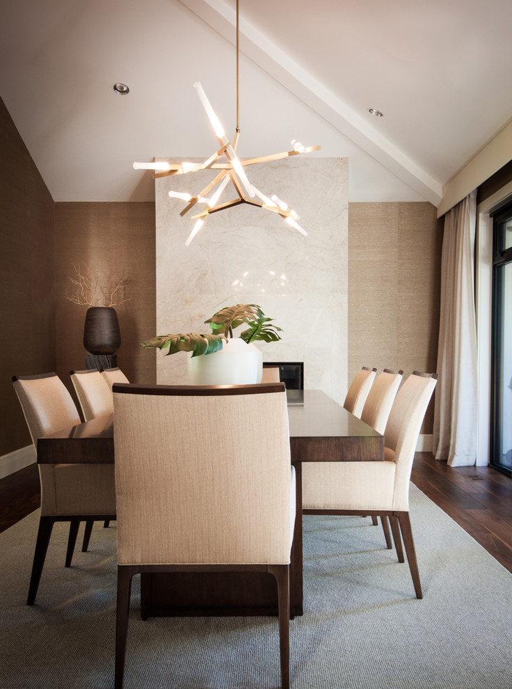 Photo of a large contemporary dining room in Vancouver with a stone fireplace surround.