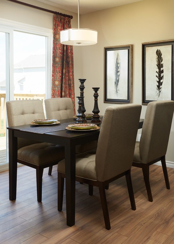 Photo of a medium sized traditional enclosed dining room in Edmonton with beige walls, light hardwood flooring and brown floors.