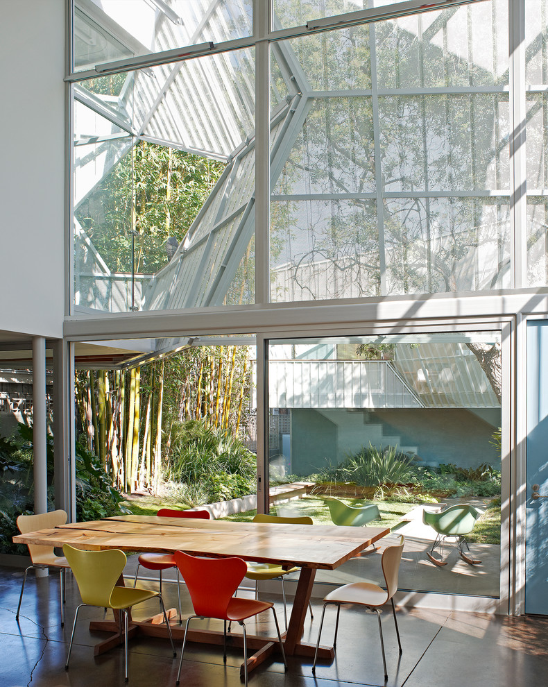 Contemporary dining room in Other with white walls.