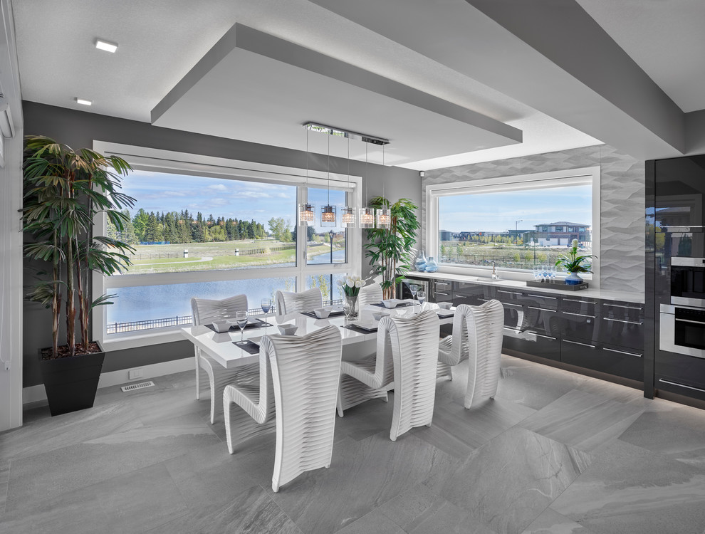 Foto di una grande sala da pranzo aperta verso la cucina contemporanea con pareti grigie, pavimento con piastrelle in ceramica e pavimento grigio