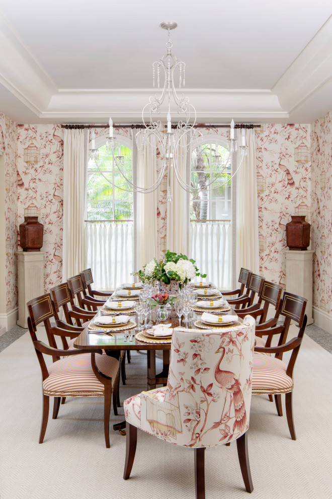 Photo of an expansive traditional dining room in Miami with limestone flooring, red walls and grey floors.