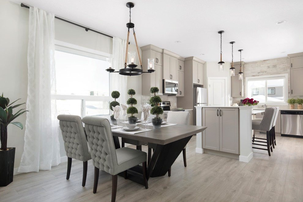 Inspiration for a mid-sized transitional laminate floor and gray floor kitchen/dining room combo remodel in Calgary with gray walls and no fireplace