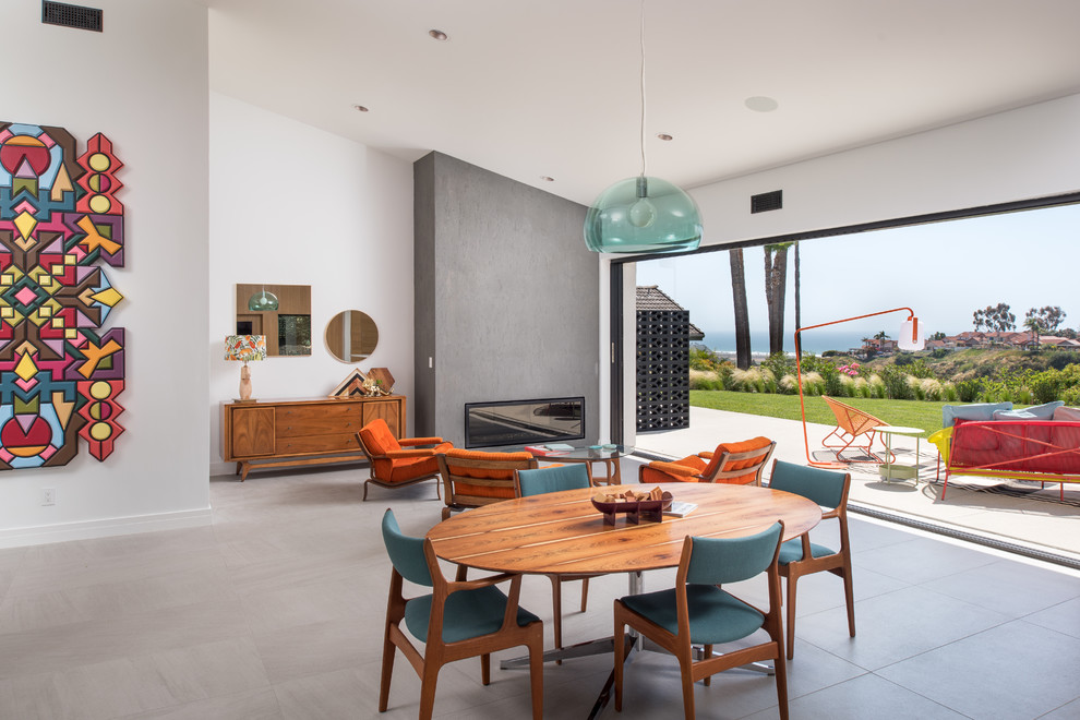 Design ideas for an expansive midcentury dining room in San Diego with white walls, porcelain flooring, grey floors and a ribbon fireplace.