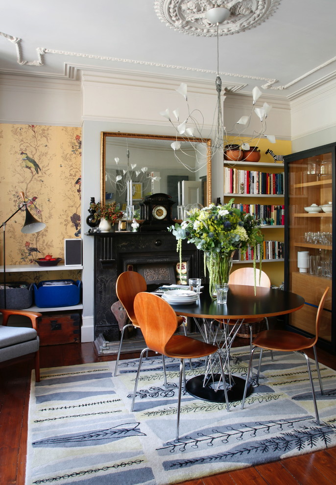 This is an example of an eclectic dining room in London with feature lighting.