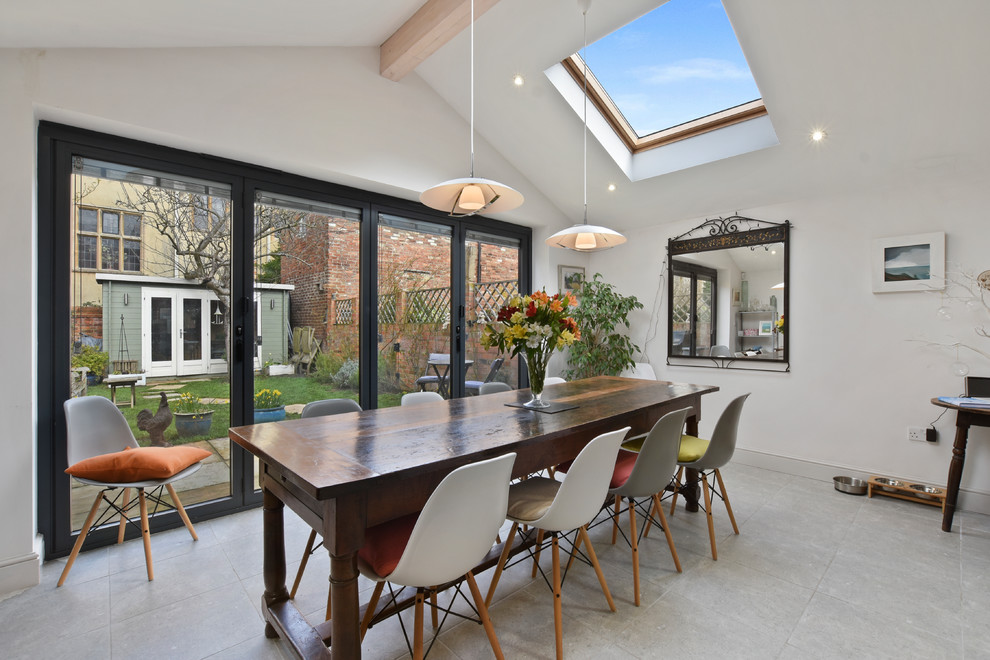 Example of a mid-sized trendy gray floor dining room design in Oxfordshire with white walls