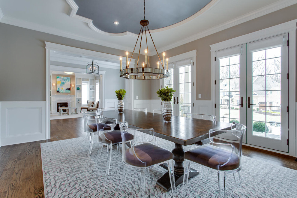 Photo of a traditional dining room in Atlanta with beige walls and dark hardwood flooring.