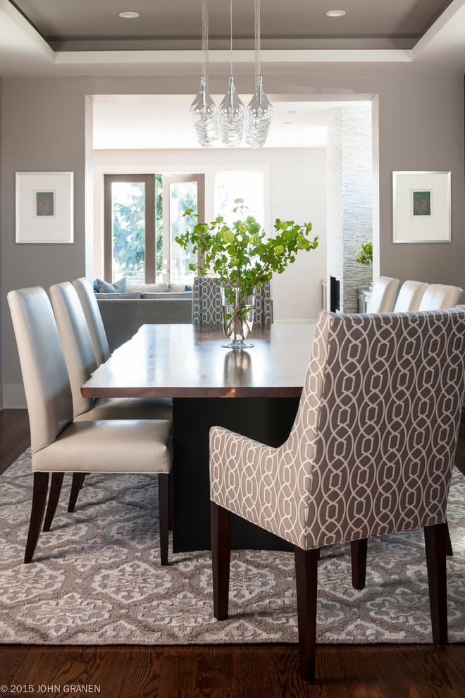 Large transitional dark wood floor enclosed dining room photo in Seattle with white walls
