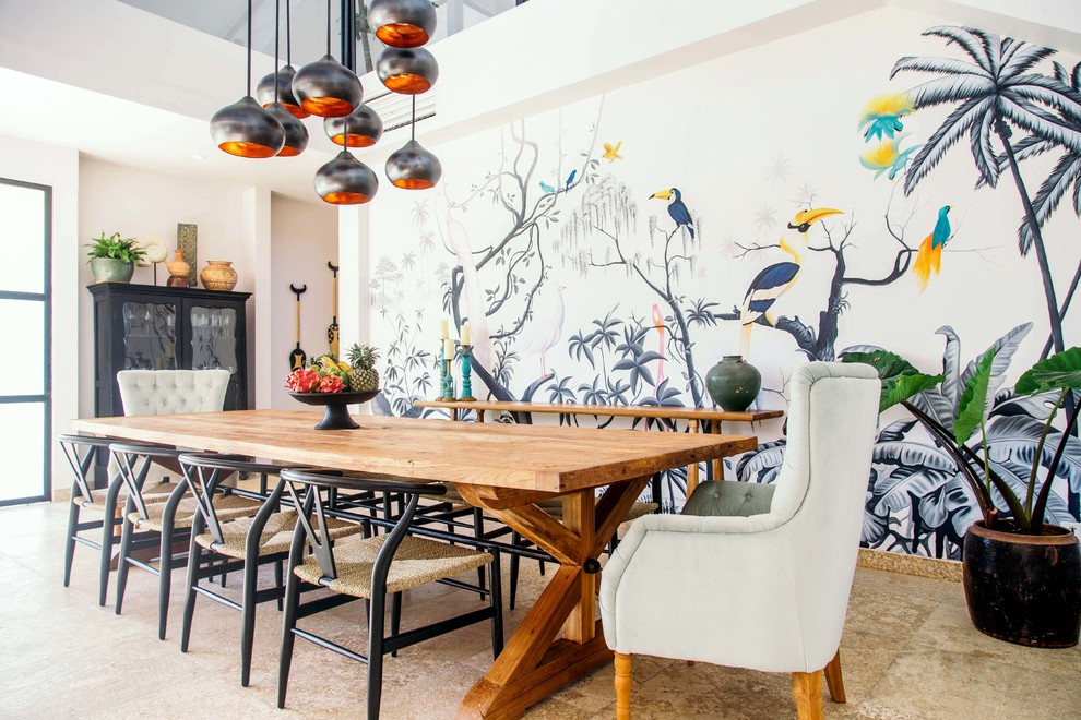 This is an example of a world-inspired dining room in San Diego with white walls and beige floors.