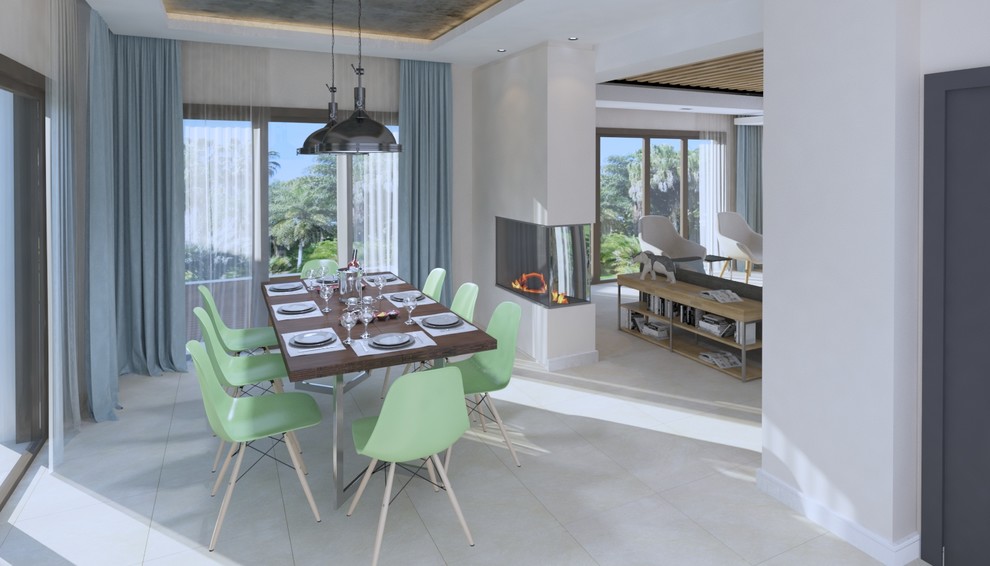 Foto di una sala da pranzo aperta verso la cucina moderna di medie dimensioni con pareti beige, pavimento con piastrelle in ceramica, camino bifacciale, cornice del camino in intonaco e pavimento grigio