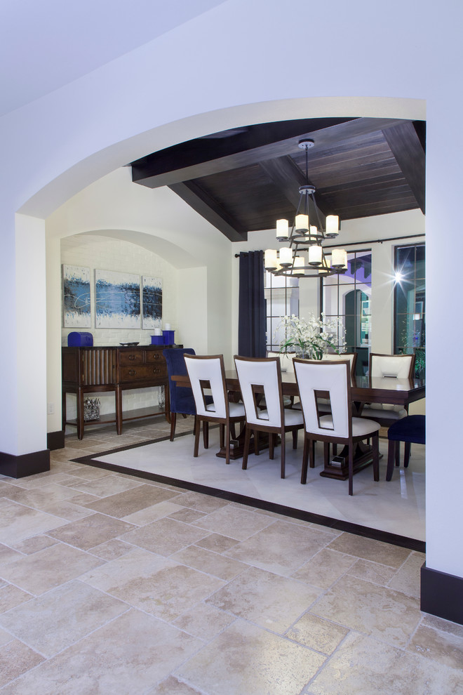 Inspiration for a medium sized contemporary dining room in Orlando with white walls and limestone flooring.
