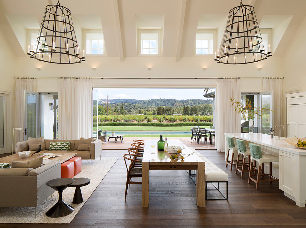 Immagine di una sala da pranzo aperta verso il soggiorno contemporanea con pareti bianche e parquet scuro