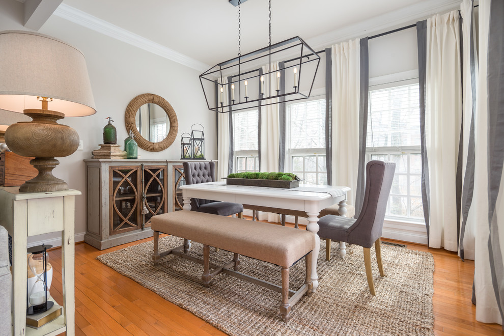 Inspiration for a farmhouse dining room in DC Metro with grey walls, medium hardwood flooring and brown floors.