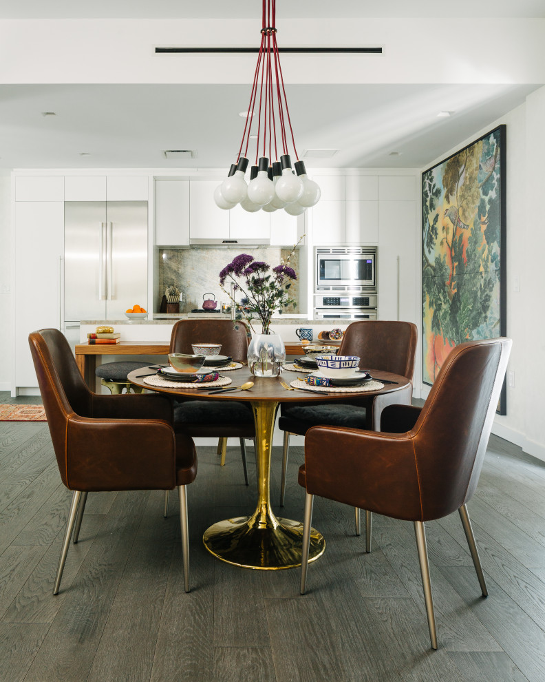 This is an example of a contemporary dining room in Tampa with white walls, dark hardwood flooring and brown floors.