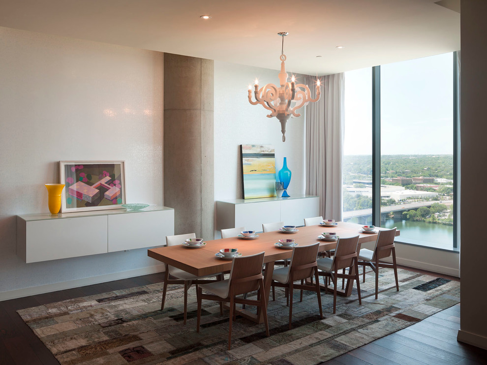 Photo of a large modern open plan dining room in Austin with white walls and dark hardwood flooring.