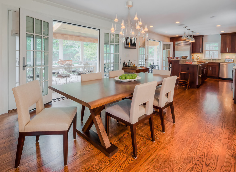 Large classic kitchen/dining room in New York with white walls, medium hardwood flooring and no fireplace.